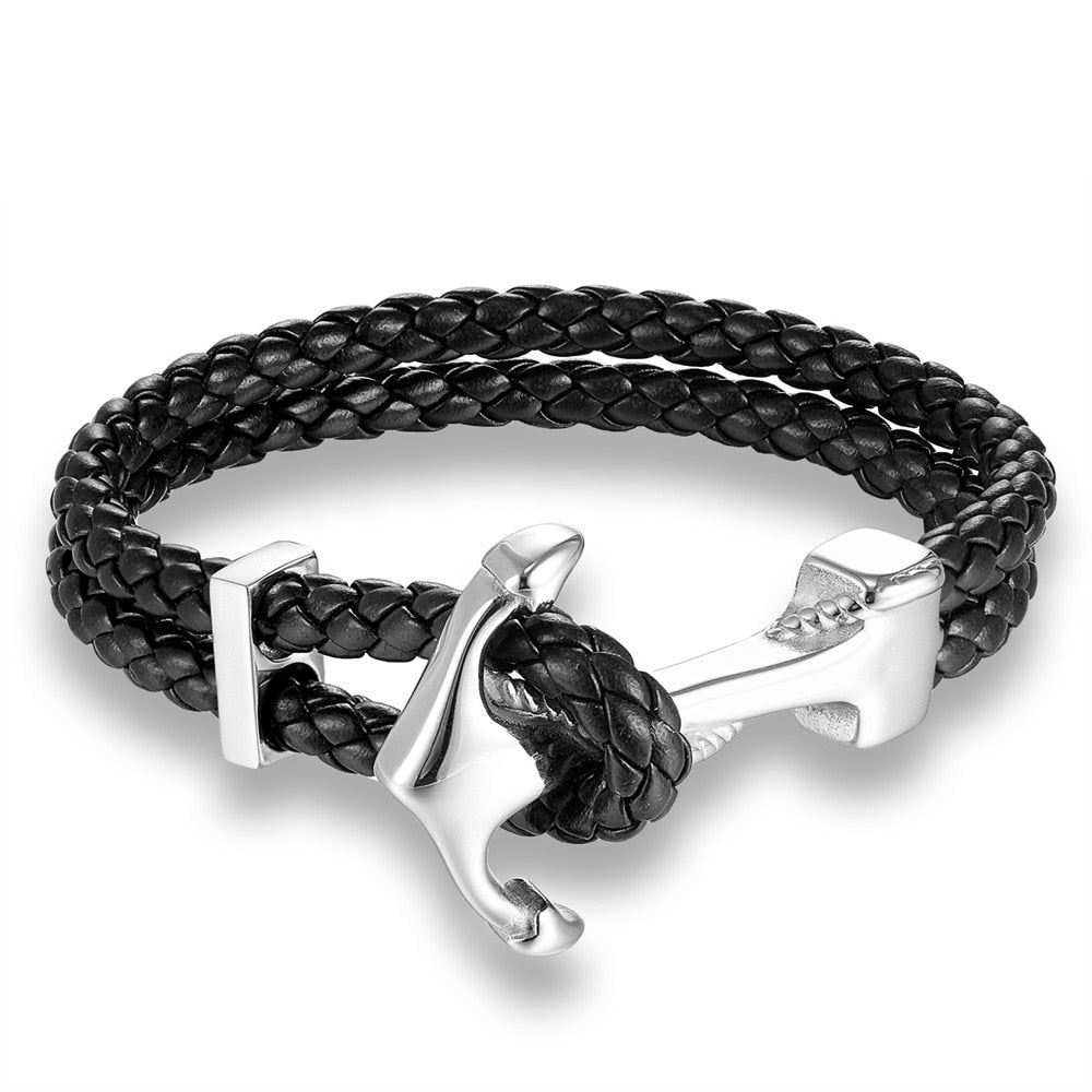 Ce bracelet, tressé de cuir et orné d'une ancre dorée, incarne l'esprit aventureux et intemporel du marin en quête de trésors