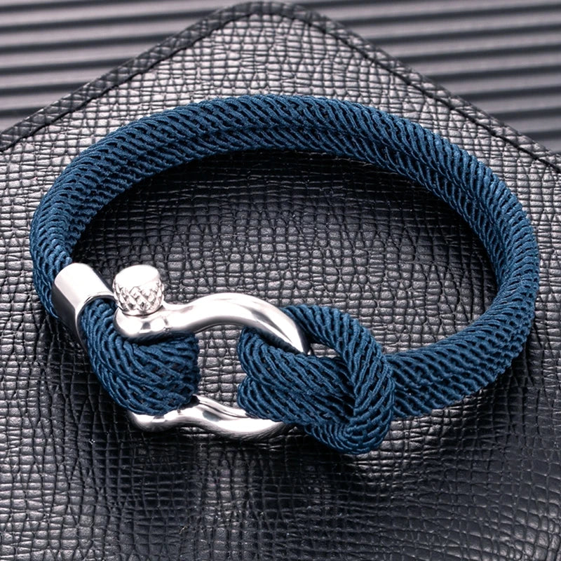 Un bracelet élégant avec un design marin, composé de corde tressée et d'un fermoir en métal brillant